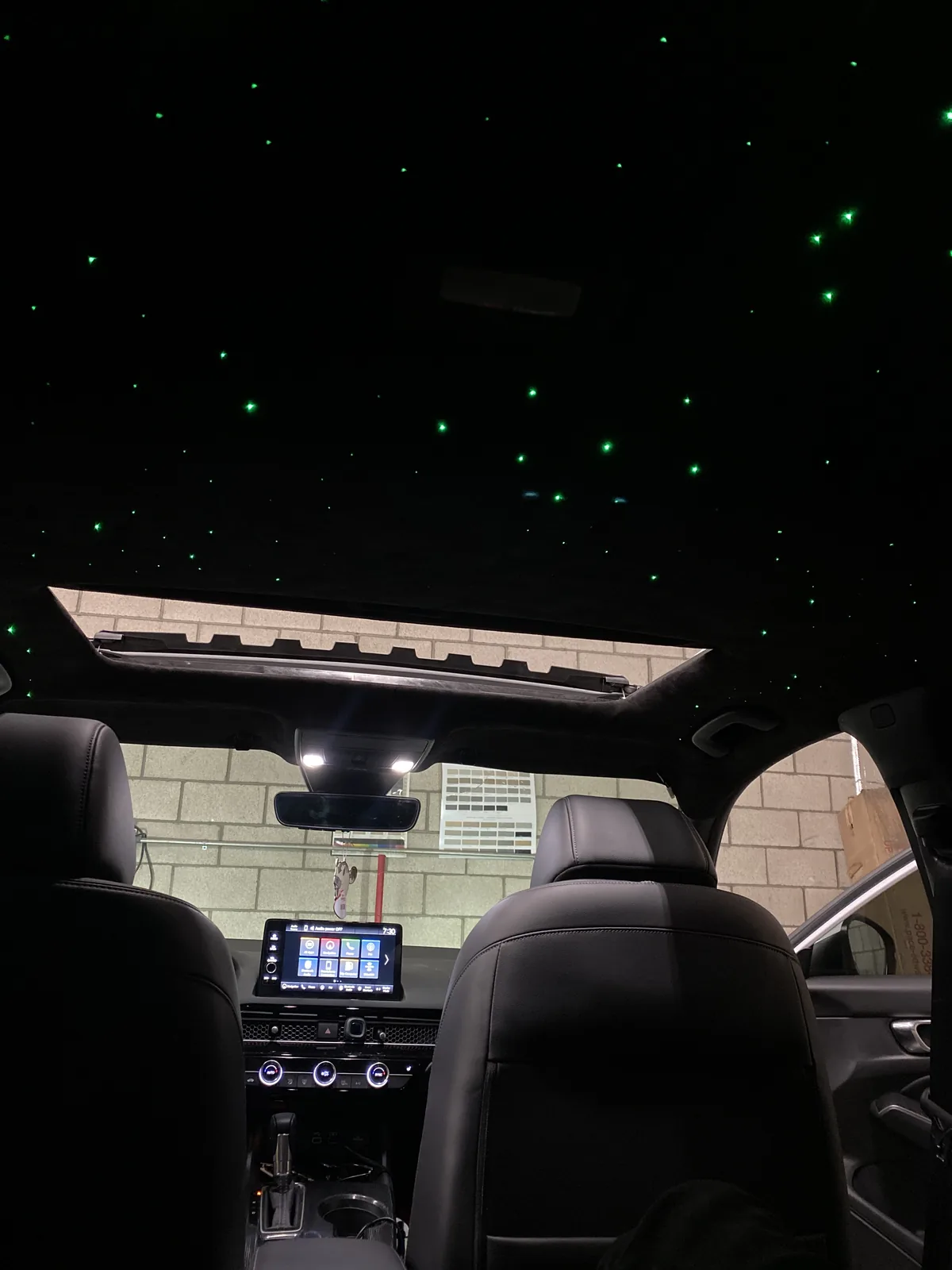 Honda Accord cabin with green starlights around the sunroof opening