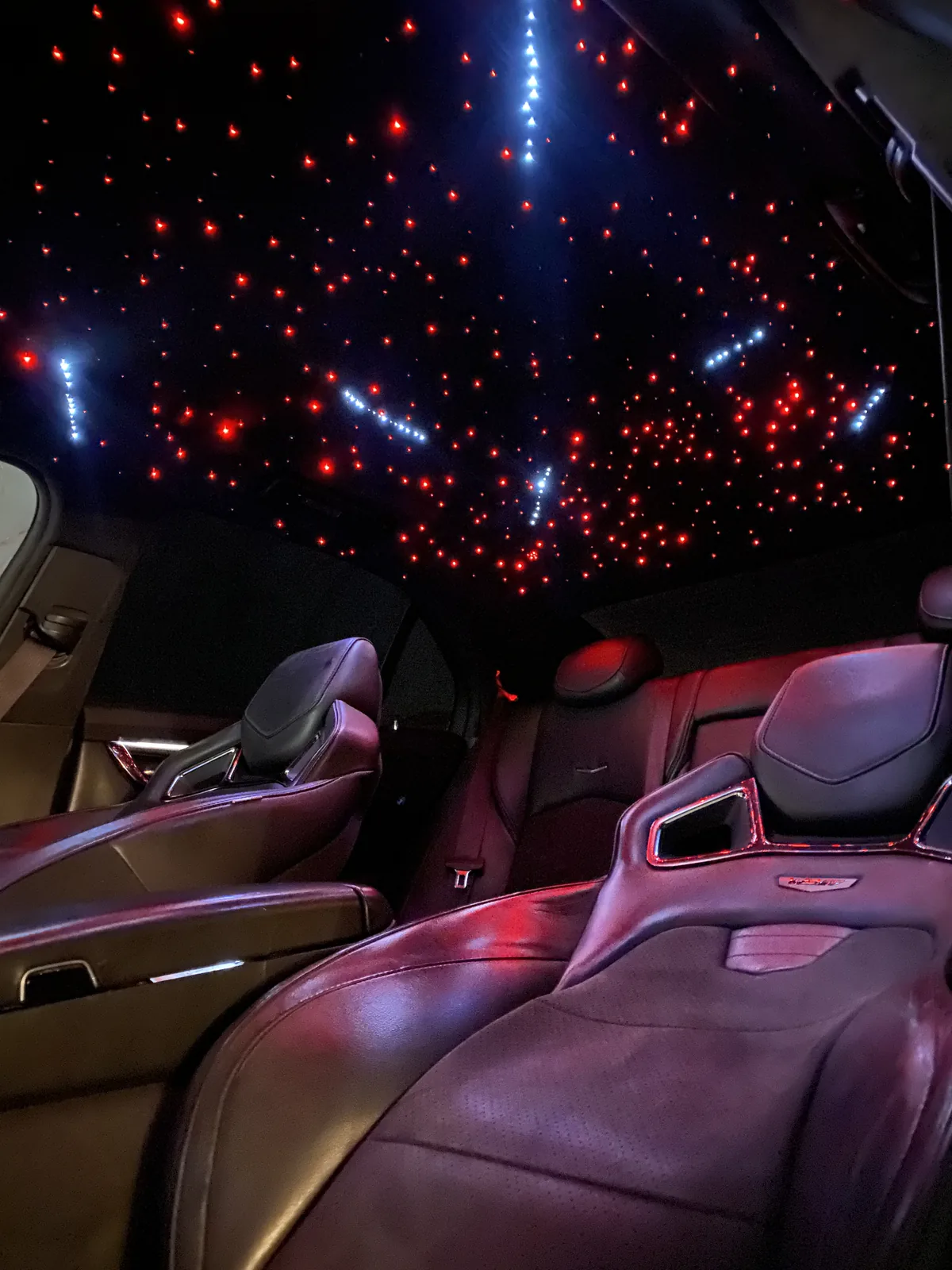 Cadillac CT5 front seats with a red and white starlight headliner and shooting-star fibers
