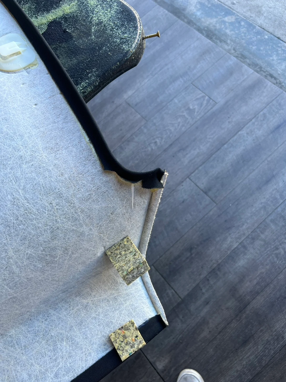 Close view of a removed headliner carrier and its fabric edge
