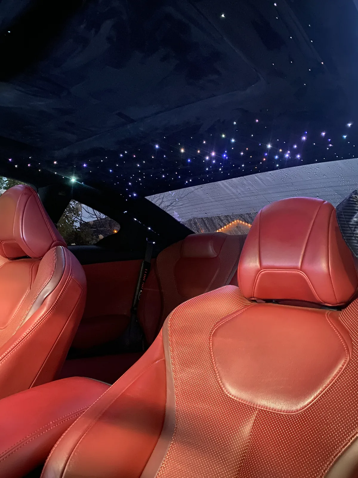 Infiniti Q60 red leather seats beneath a starlight headliner