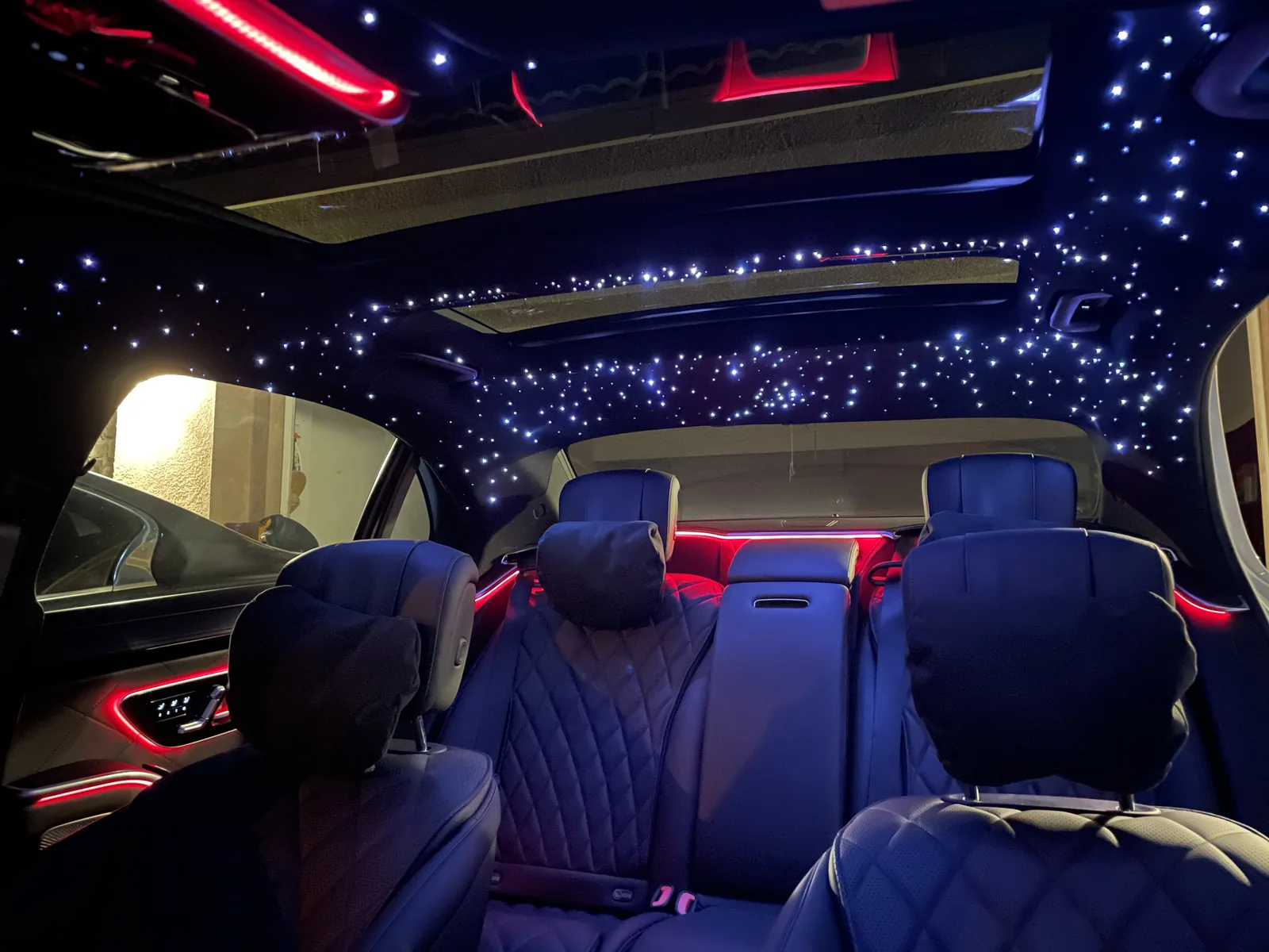 Mercedes-Benz S-Class rear seats with diamond stitching under a starlight headliner and red ambient trim