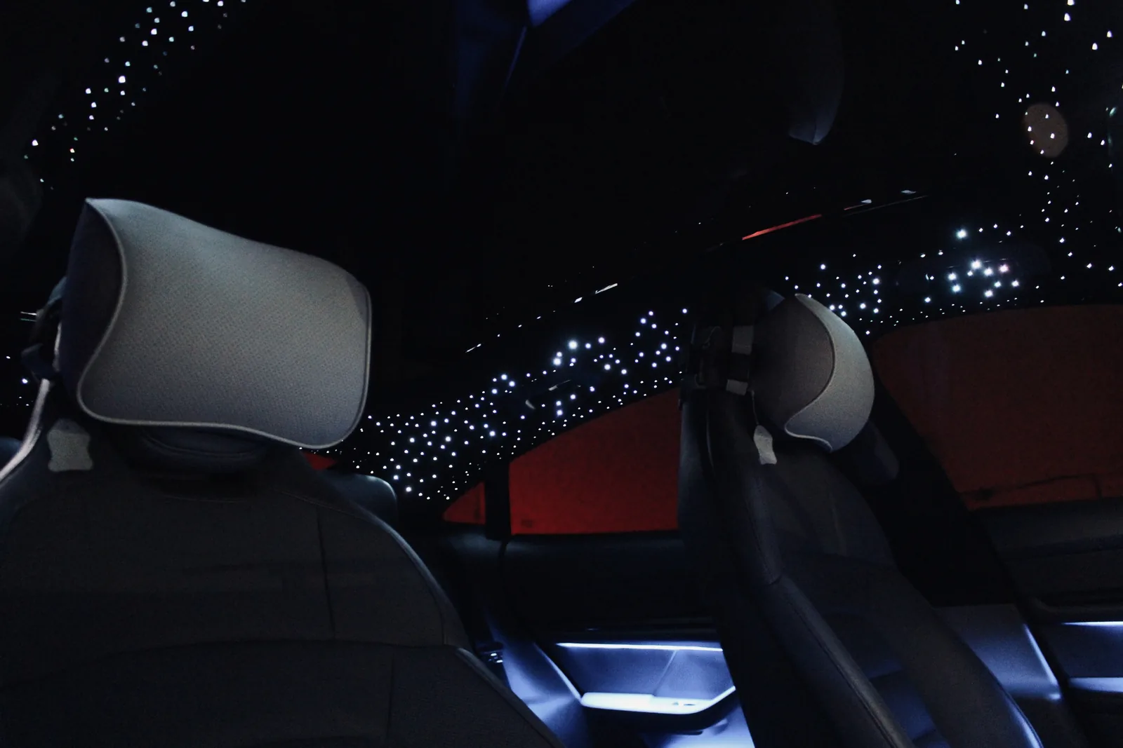 Porsche Taycan two-tone cabin under a white starlight headliner with cool ambient lighting